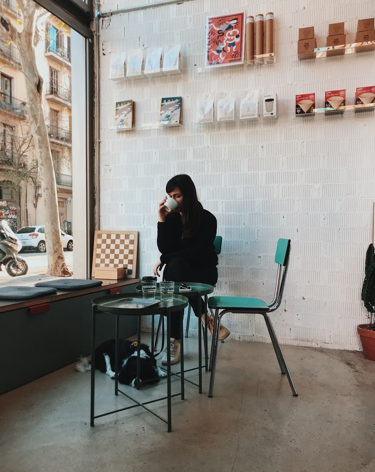 Isa and our dog, Alice, at Three Marks Coffee in Barcelona